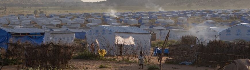 War, Famine, and Atrocities in Sudan. Women and children walk through the Djabel refugee camp in Eastern Chad.